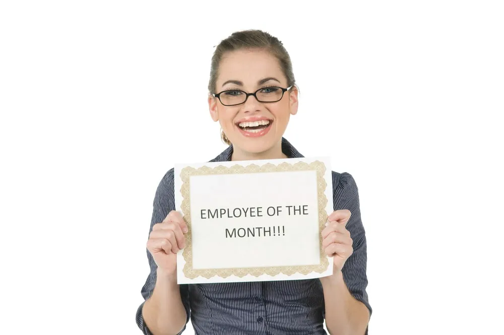 Smiling businesswoman with colleagues in the background