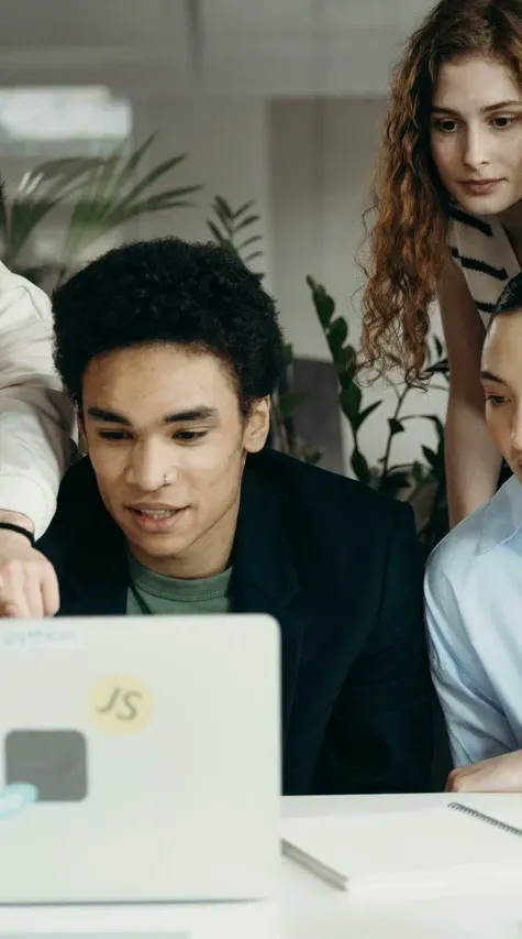 Employees working at computers with employee monitoring software